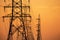 High voltage electric transmission tower. High voltage power lines on electric pylon against a sunset sky. Electrical