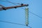 High-voltage electrical insulator electric line against the blue sky