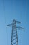 High voltage electricity cables over a blue sky