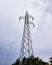 High voltage electricity pylon standing against sky