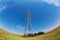 High-voltage electricity pylons against blue sky