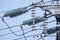 High voltage insulators of overhead power line are under blue sky