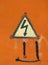 High voltage lightning sign in yellow triangle on rusty metal door, grunge abstract background