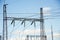 High voltage metal transmission tower against a blue sky