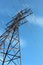 High voltage pole stands against the blue sky