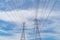 High voltage poles. Power lines on utility tower and cable wires in energy electric technology, network, and industry concept.