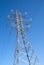 High-voltage power line metal prop over blue sky