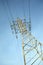 High-voltage power line metal prop over clear cloudless blue sky