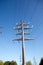 High-voltage power line metal prop over clear cloudless blue sky