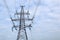 High voltage power line. Steel construction of the mast. Wires, insulators against the blue sky.