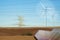 High voltage power line, wind turbines and photovoltaic panel in desert