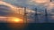 High-voltage power lines at dusk against the backdrop of the setting sun in an open area