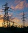 High-voltage power lines during fiery sunrise