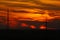 High voltage power lines on a red, fire sunset