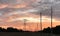 High-voltage power lines at sunrise transmission towers. Photo image