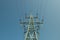 a high-voltage power transmission line, in the photo, a power line support against a blue sky