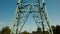 a high-voltage power transmission line, in the photo, a power line support against a blue sky