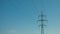 a high-voltage power transmission line, in the photo, a power line support against a blue sky