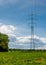 High Voltage Pylon in Sunlit Landscape
