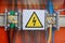 High voltage sign. Electrical relays and wires.