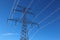 High voltage steel pylon against blue sky