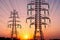 High voltage tower. High voltage. Electricity transmission power lines at sunset (high voltage pylon). Aerial view