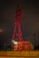 High voltage tower lightened with red light in evening