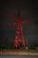 High voltage tower lightened with red light in evening