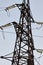 High-voltage towers against the blue sky. High-voltage electrical insulator. Electric hub on pole. Wires of high voltage in sky.