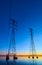 High voltage transmission lines crossing Wheeler Lake at dusk near Athens AL. Electricity pylons at sunset. Power and energy