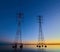 High voltage transmission lines crossing Wheeler Lake at dusk near Athens AL. Electricity pylons at sunset. Power and energy