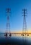 High voltage transmission lines crossing Wheeler Lake at dusk near Athens AL. Electricity pylons at sunset. Power and energy