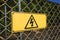 High Voltage warning sign on wires fence net
