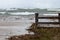 High water and large waves eroding the shore and deck at the beach