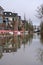 High water level causes flooding in a Dutch city street with sandbags in 2024.