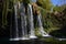 A high waterfall with several streams falls from a green hill surrounded by hanging plants, vines and greenery