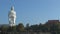 High white Buddha stands on a background of blue sky. panorama. The temple stands on the mountain.