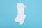 High white children`s socks with big bows for festive clothes on a blue background top view