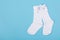 high white children\\\'s socks with big bows for festive clothes on a blue background top view