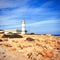 High white lighthouse on a rocky sea coast