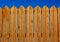 High wooden fence painted brown deck pattern