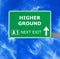 HIGHER GROUND road sign against clear blue sky