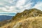 Highland mountain top peak rocky stone ground scenic view common landscape with cloudy blue sky background space