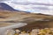 Highland mountains in the Bolivian Andes. Calm waters stream in the flat desert.