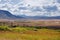 Highland river valley with yellow and orange grass near the border line with Mongolia