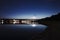 Highlighted bridge at night and reflected in the water