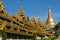 The highly decorated covered approach to the Shwedagon pagoda -