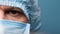 Highly Detailed Portrait Employee Laboratory in Personal Protective Suit in Blue Background. Half Face. Close Up Male