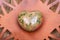 Highly polished puffy Unakite Heart from Unakas Mountains in North Carolina, on Rustic Orange plate.