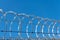 highly protected prison wall with barbed wire fence. steel grating fence